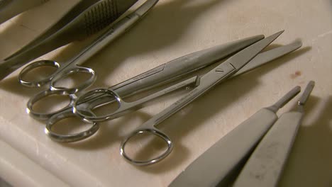 scissors and embalming tools on a table