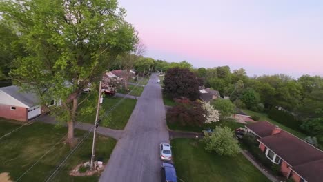 Aerial-approaching-shot-of-idyllic-neighborhood-in-Suburbia-of-USA-at-golden-hour