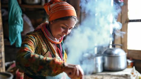 female homesteader stirring contents in cast iron pot over vintage stove, generating steam within warm wooden kitchen of rustic cabin, embodying traditional culinary heritage