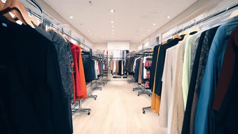 inside a clothing store with racks of clothes on display.