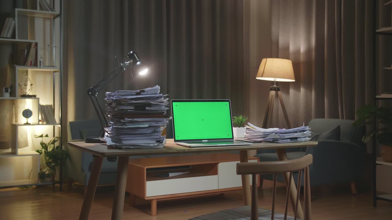 Green Screen Laptop With Documents On The Table At Home