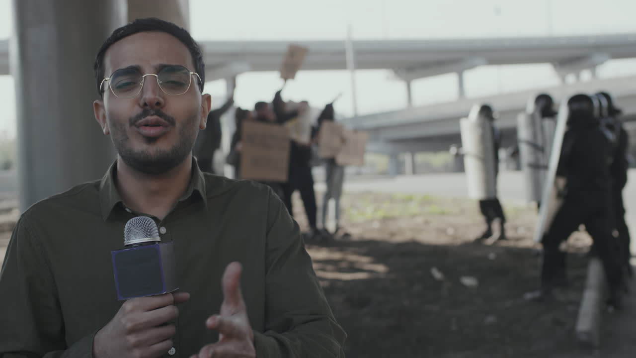 News reporter covering a protest with riot police