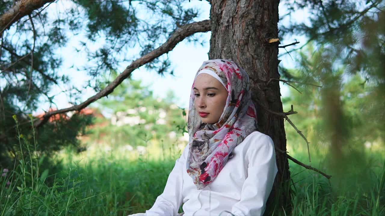 Woman in Hijab Relaxing in a Forest