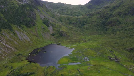 high angle view of a soaked valley below a flowing cascading stream in the mountains