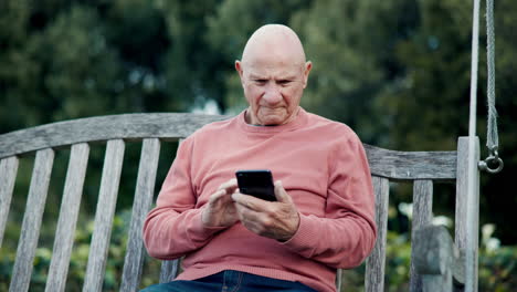 Elderly,-man-and-outdoor-with-phone-on-bench