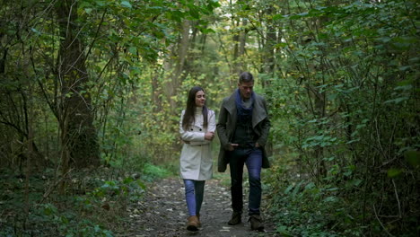 a couple walking in the woods