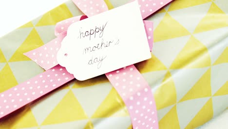 gift box with happy mothers day tag on white background