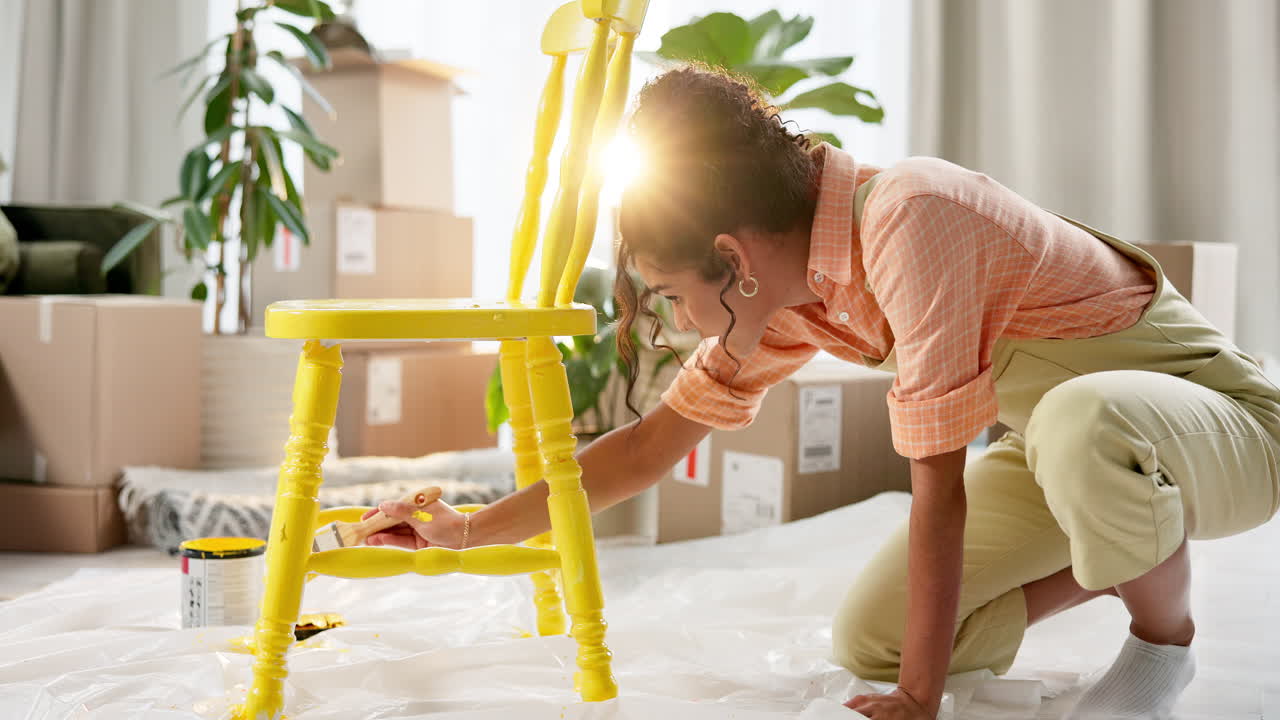 Woman painting a chair yellow