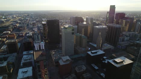 denver, colorado usa. ariel view of metropolitan area during sunrise. skyscrapers and highways meet suburban area.