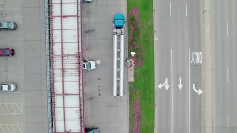 ascending bird-eye aerial view over semi truck tanker bringing fuel for gas station, location in vernon hills, illinois, usa