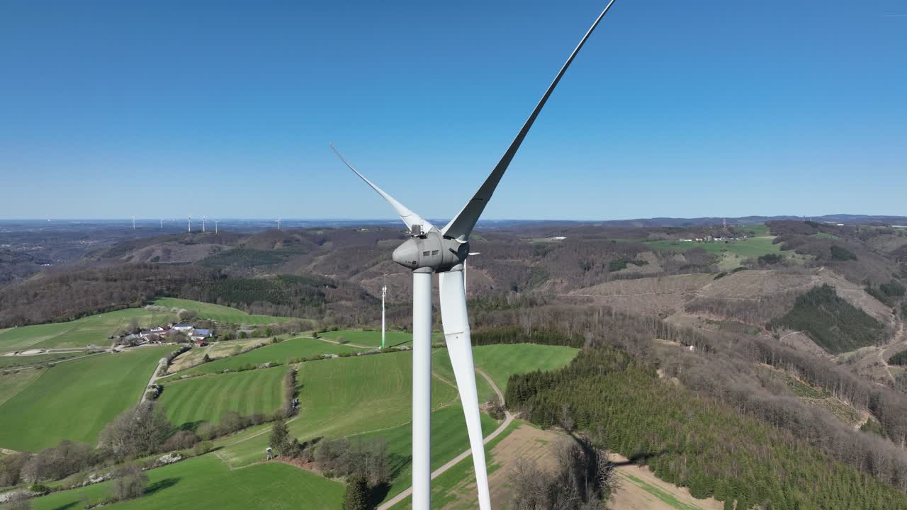 Clean eenrgy production, power from the wind, electricity, renewable energy, wind power, wind turbines in green landscape. Aerial view. close up.