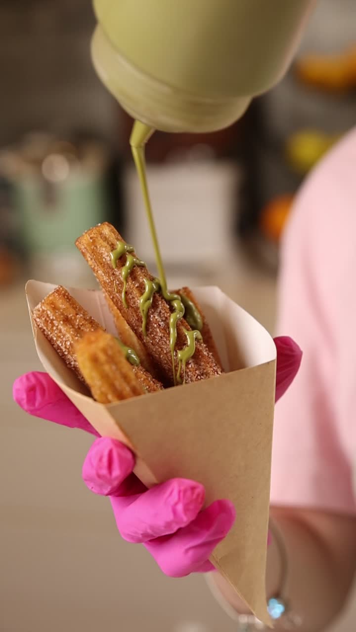 Churros with green sauce being prepared
