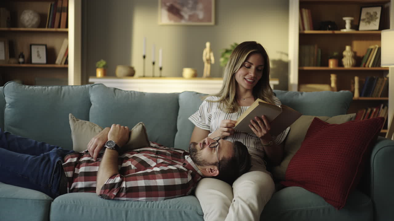 Couple Relaxing on Couch Reading a Book