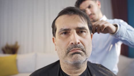 The-young-man-caring-for-his-father-shaves-him-at-home.