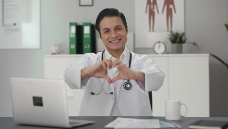 happy indian doctor showing heart sign