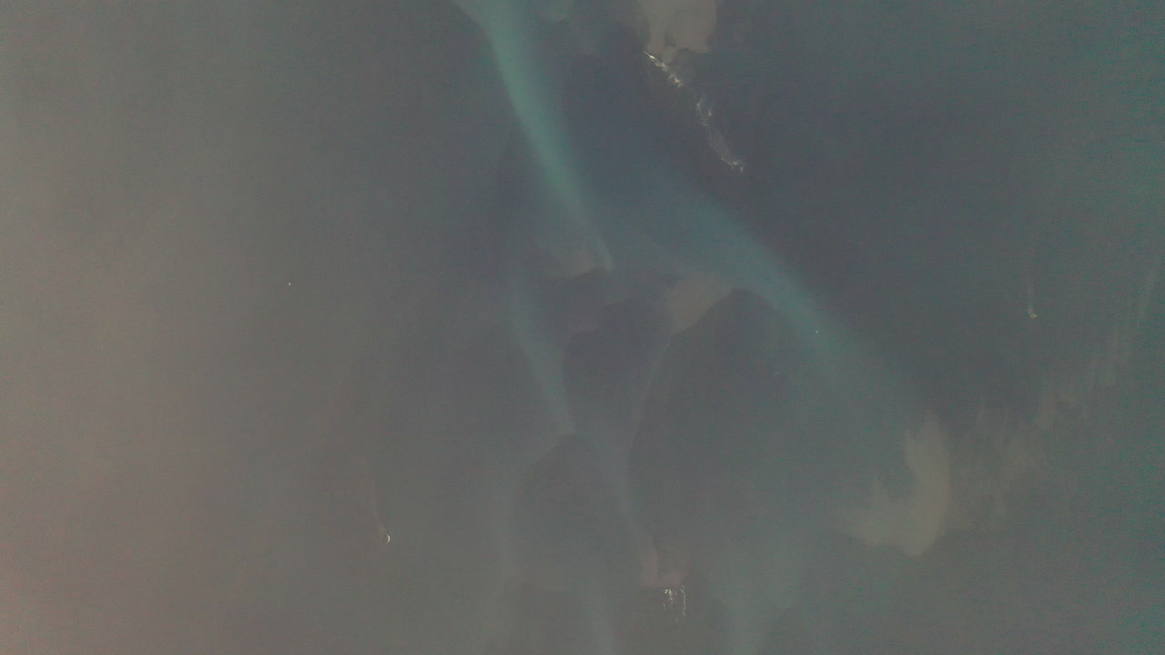 volando por encima de las nubes con vistas al lecho del río glacial azul en el sur de islandia