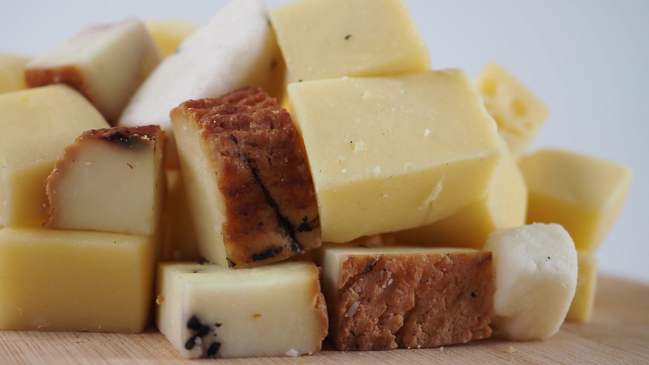 Assortment of Cheese Cubes on a Wooden Serving Board