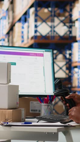 vertical video female warehouse clerk registering barcodes for packages