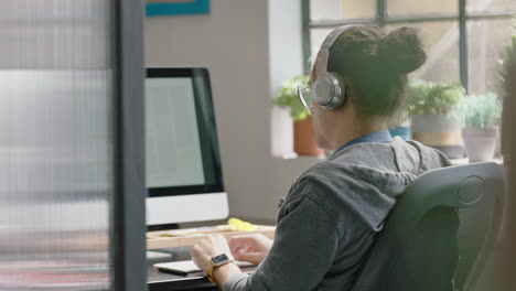 young-caucasian-businessman-using-computer-typing-browsing-online-research-focused-entrepreneur-working-in-startup-office-brainstorming-listening-to-music