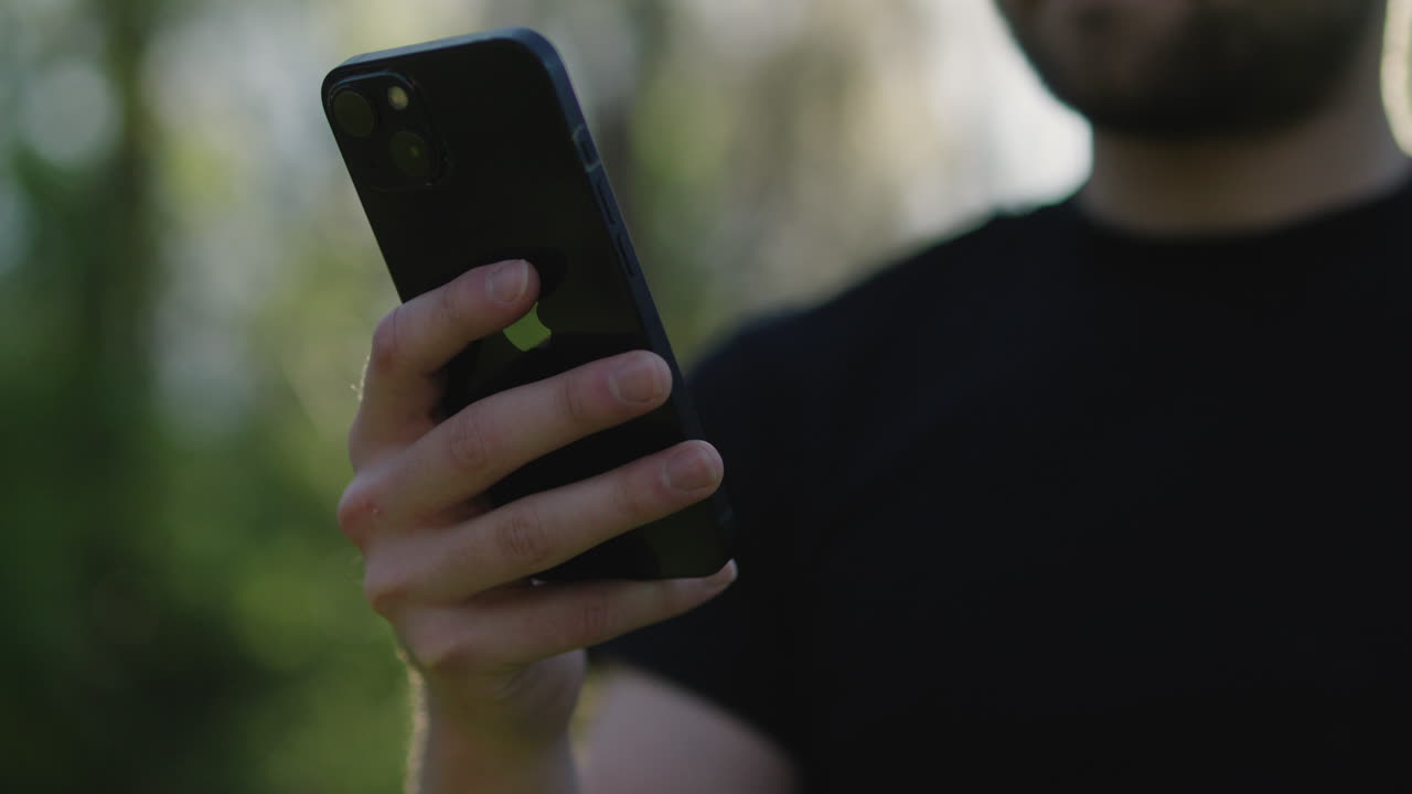 Man using an iPhone outdoors