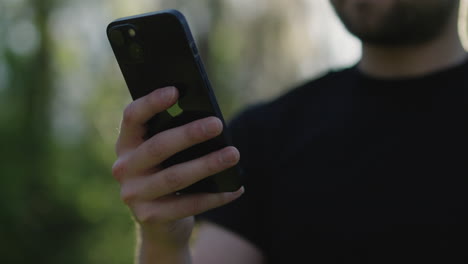 man using an iphone outdoors