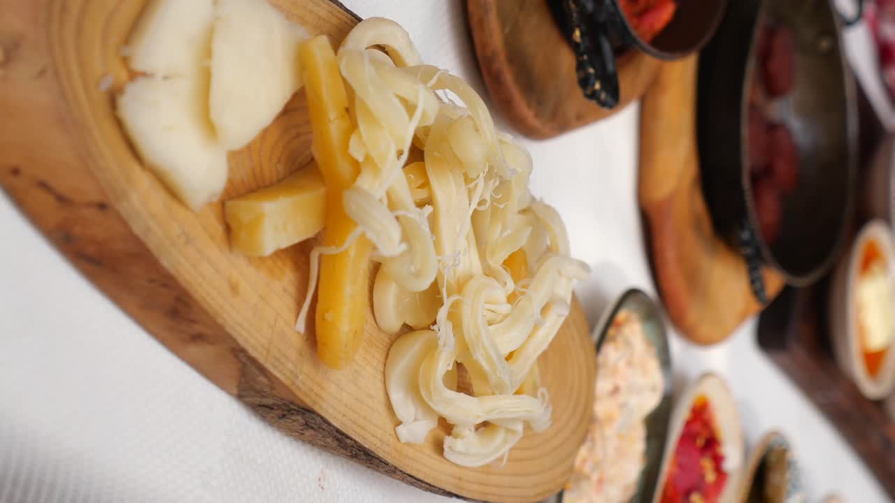 Close-up of cheese and dishes on wooden boards
