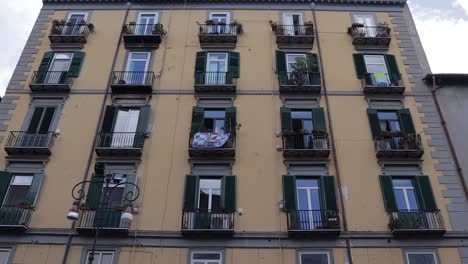 Residential-apartment-block-facade-with-small-window-balconies-Naples-Italy-LOW-ANGLE