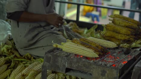 arabic man is preparing a corn and selling on the street