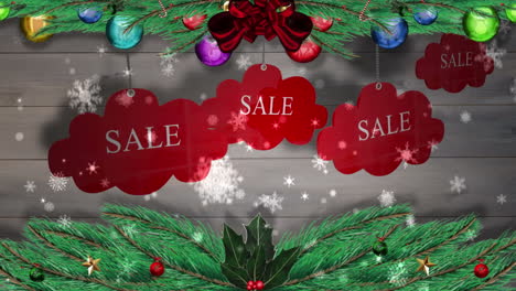 Red-sale-tags-hanging-against-wood-with-festive-decorations