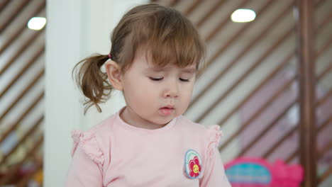 Adorable-Caucasian-3-Year-Old-Girl-with-Pigtails-Looking-Aside-Being-Upset-in-Bad-Mood