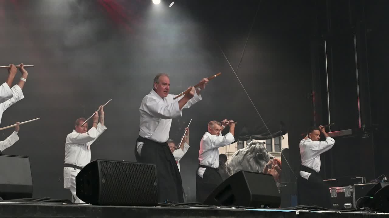Aikido Demonstration: Skilled Martial Artists Perform with Bo Staffs on Stage