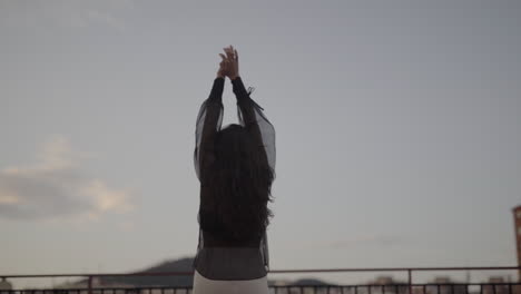 woman in black ritual cult dancing slowly at sunset barcelona