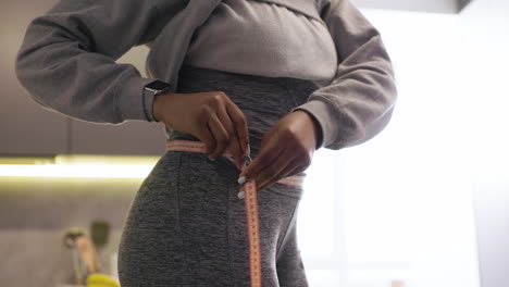 woman measuring waist