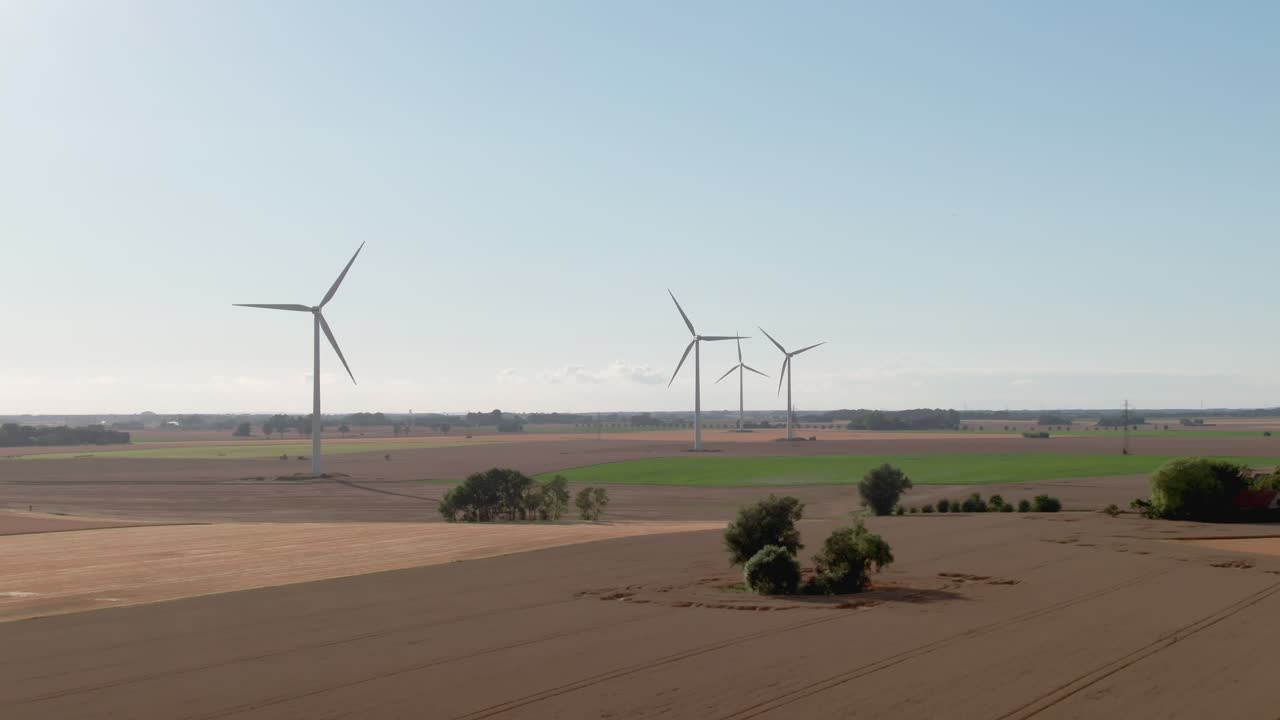 Wind turbines and Swedish countryside on sunny summer day in in a drone descent scene