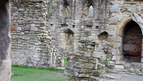 Ancient-Basingwerk-abbey-abandoned-historic-landmark-building-stone-ruin-walls-dolly-right