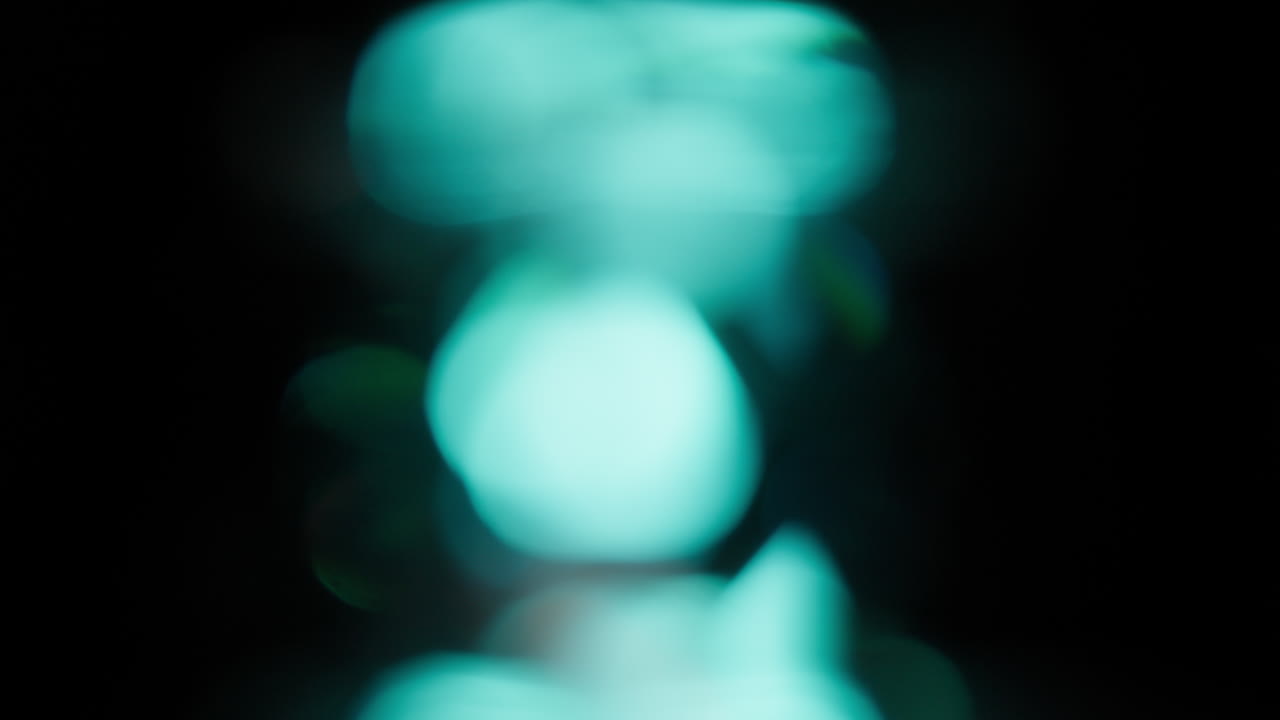 Abstract Bokeh Of Light Leaks Orange And Blue Colored In Black Background