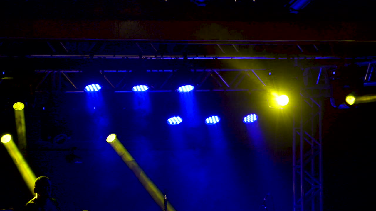 Stage lighting with yellow and blue lights at live concert