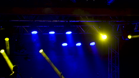 stage lighting with yellow and blue lights at live concert