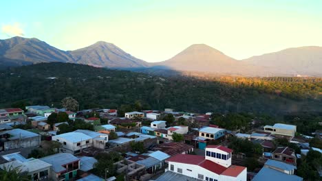 drone shot city surrounded by volcanoes and mountains central america