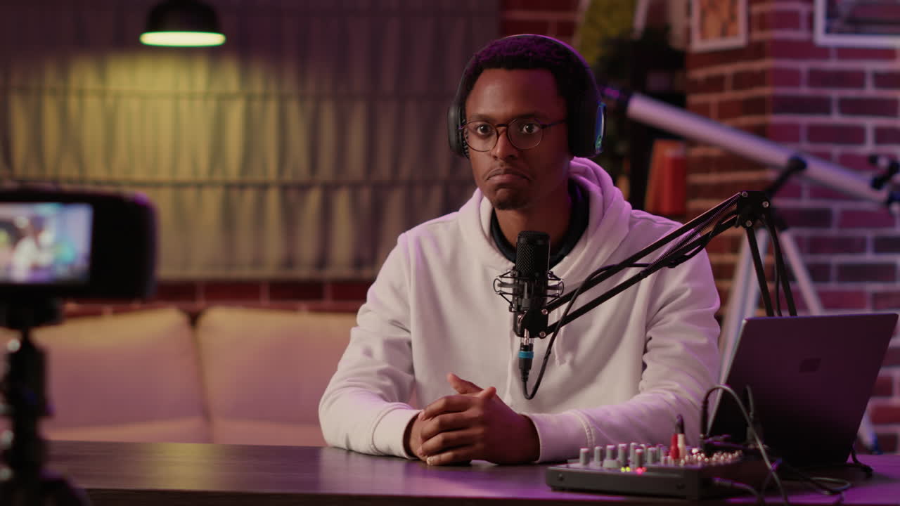 African american content creator recording vlog using digital video camera saying thank you for watching his show