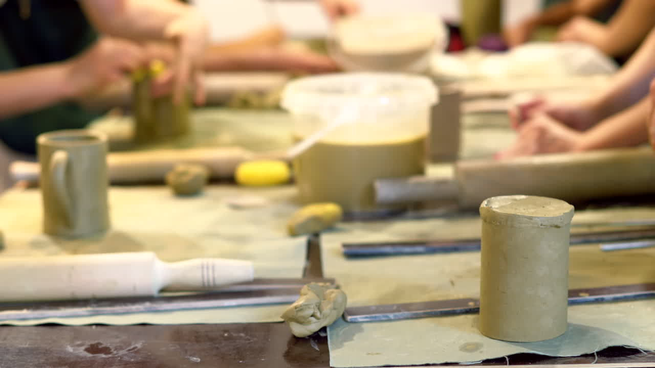 Students modelling clay into cups