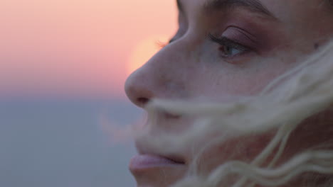 close up portrait of beautiful woman enjoying peaceful seaside at sunset contemplating journey exploring spirituality feeling freedom with wind blowing hair