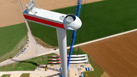 the head of the wind turbine is presently undergoing construction - aerial pullback