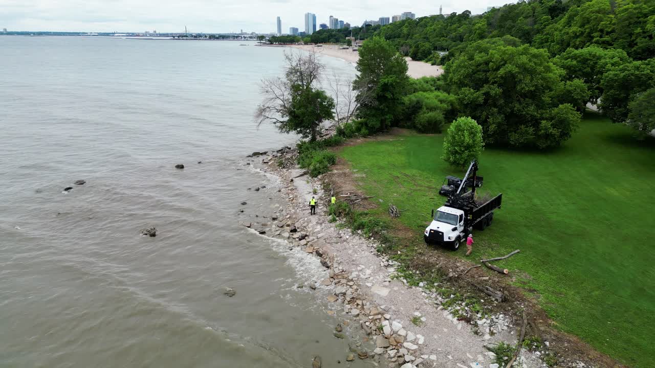 City Construction Workers Assessing Rising Water Levels And Using Flood Prevention Methods To Protect A Lakefront ParK In Milwaukee, Wisconsin.