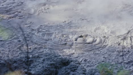 Boiling-hot-geothermal-volcanic-mud-pool,-closeup-shot-steamy-lake-bubbling-mud-and-steam-satisfying