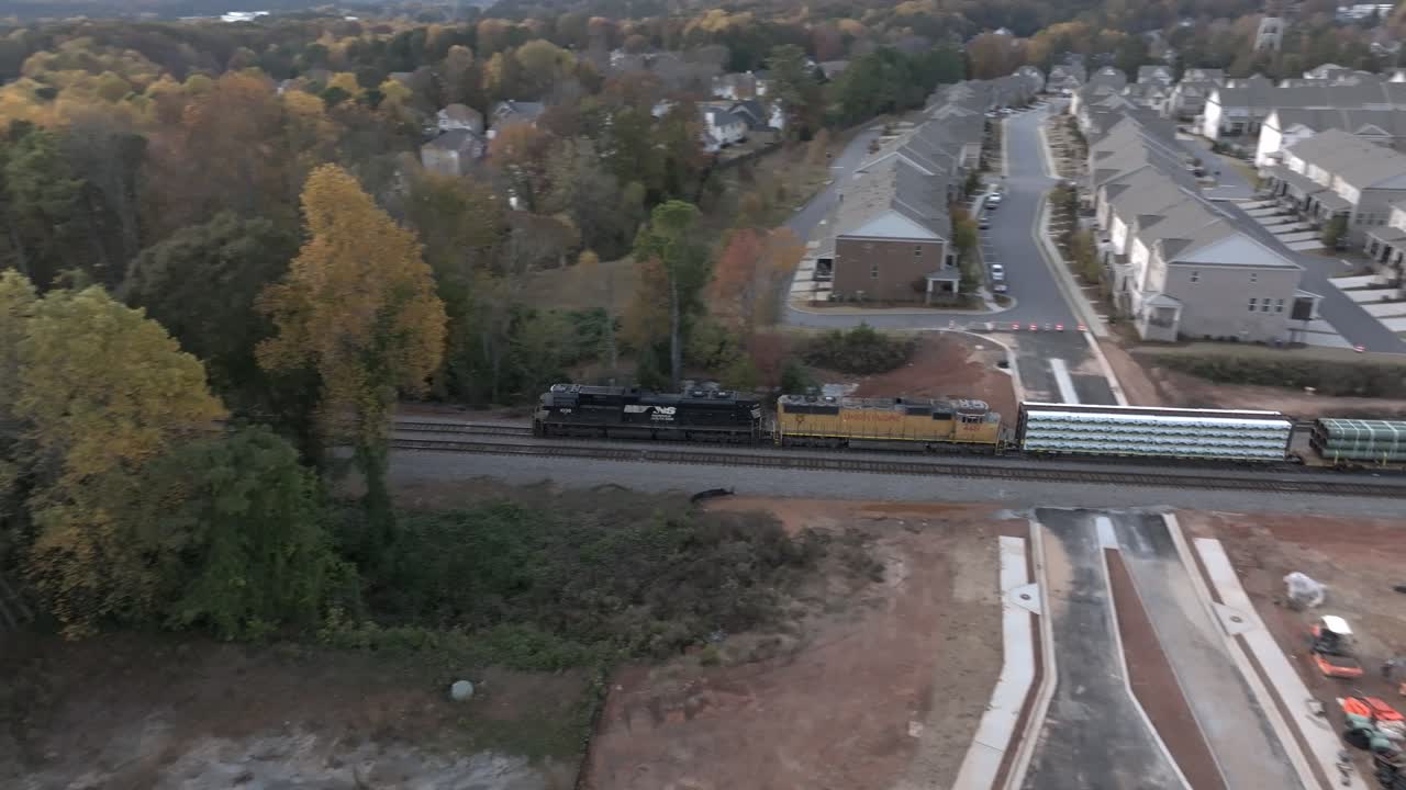 Cinematic drone shot of freight train carrying steel pipes, Atlanta, Georgia, USA