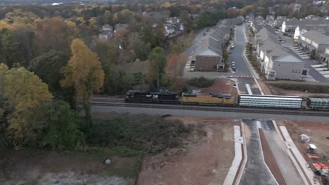 cinematic drone shot of freight train carrying steel pipes, atlanta, georgia, usa