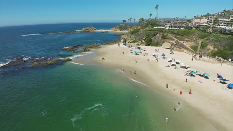 backwards aerial view over treasure island in laguna beach in southern california