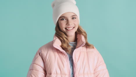 teenage caucasian girl with winter clothes in front of the camera.