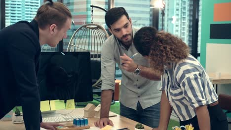 Creative-business-people-group-having-conversation-at-office-desk-in-workplace.